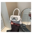 Detail of glittery mini handbag with a sparkling rhinestone bow and silver chain strap - White Type 2