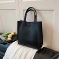 Minimalist black faux leather tote bag with sturdy top handles and sleek vertical design - Black