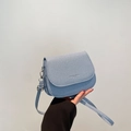Minimalist light blue saddle bag with fine grain texture and silver hardware - Blue