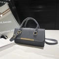 Dark grey textured fabric handbag with gold hardware and adjustable crossbody strap - Black