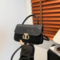 Chic black leather handbag with sparkling dark grey flap and gold geometric buckle detail - Black