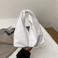 White minimalist croissant bag with a twisted handle made of soft synthetic leather - White