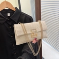 Beige woven straw flap crossbody bag with square gold buckle and chain shoulder strap - Off White