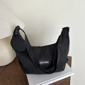 Minimalist black canvas shoulder bag with small round coin pouch and white logo - Black