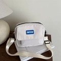 Minimalist off-white crossbody square bag with blue logo patch and adjustable strap - White