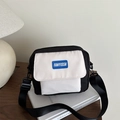 Minimalist black and white canvas crossbody bag with adjustable wide strap and logo detail - Black and White