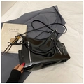 Detail of glossy black tote bag featuring twin decorative metal zippers and side pockets - No Pendant / Black