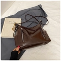 Detail view of large brown tote bag with glossy finish and metal tennis racket charm - No Pendant / Brown