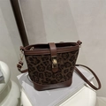 Vintage bucket bag featuring dark leopard print with brown leather trim and gold buckle - Brown