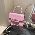 Light pink crossbody bag with textured leather panel and elegant gold metal clasp - Pink