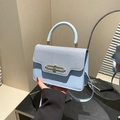 Elegant light blue crossbody handbag with denim texture and golden metallic lock - Blue