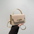 Beige patchwork top handle bag with woven texture and gold metal buckle detail - Khaki