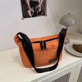 Minimalist orange canvas crossbody messenger bag with black adjustable strap and fashion label - Orange
