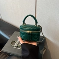 Close-up of dark green quilted leather vanity case with gold zippers and chain strap - Green