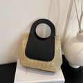 Contrast straw tote bag featuring a black leather panel with circular cutout handle - Black