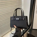 Classic black pebbled leather handbag with silver twist lock and adjustable shoulder strap - Black
