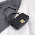 Classic black leather crossbody bag with elegant gold hardware and chain strap - Black