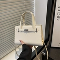 Elegant beige lychee leather handbag with silver twist lock and slim shoulder strap - White
