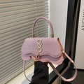 Pink glitter crossbody bag with gold SSS logo and fringe detail held by a model - Pink