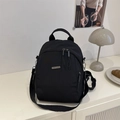 Minimalist black waterproof nylon backpack with adjustable straps and silver metal logo - Black