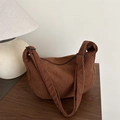 Brown corduroy crescent crossbody bag with adjustable strap in warm indoor setting - Brown