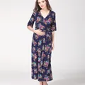 Macro detail of the V-neck wrap design and vibrant floral print on navy maternity dress - S / Dark Blue