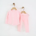 Detail view of pink cotton kids' pajama set hanging on a minimalist wooden hanger - Pink / 120cm