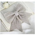 Sparkling silver glitter Christmas bow ornament shown in a decorative still life setting - Rose Gold