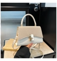Detail of white leather and straw handbag with golden square lock and adjustable strap - White