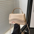 Minimalist beige faux leather crossbody handbag with unique wave-patterned flap - Khaki