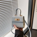 Mini light blue crocodile pattern crossbody bag with golden metal twist lock and top handle - Blue