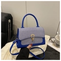 Detail of blue leather and striped fabric handbag with golden water drop twist lock - Blue