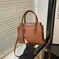 Dark brown leather handbag with lychee texture and adjustable crossbody shoulder strap - Brown