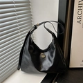 Classic black leather hobo bag with adjustable strap in natural window light - Black