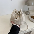 Chic cream straw bucket bag with cotton drawstring closure and woven pattern detail - White