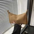 Beige woven underarm bag featuring a metallic gold chain strap and textured straw finish - Brown