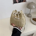 Beige woven straw bucket bag with white drawstring closure and tassel for summer vacation - Khaki