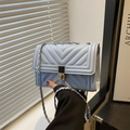 Sky blue quilted crossbody bag with silver square lock and elegant metal chain strap - Blue