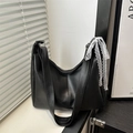 Detail of black PU leather hobo bag with white lace ribbon bow and wide strap - Black