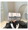Detailed view of white leather shoulder bag with diamond rhinestones and silver T-lock - Gold