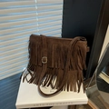 Brown faux suede crossbody bag featuring long fringe tassels and adjustable gold buckle strap - Brown