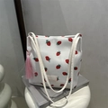 Witte canvas bucket tote met aardbeienprint en roze kwastje als detail - Aardbei