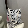 Canvas emmer-tas met zwarte vlinderprints en een roze kwastje als decoratie - Vlinder Zwart
