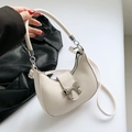 Creamy white half-moon shoulder bag with a silver metal bow buckle and PU leather texture - Off White