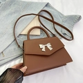 Brown leather trapezoid handbag with silver bow detail and adjustable shoulder strap - Brown