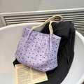 Borsa tote lavanda con fiocchi e manici in corda color crema su uno sfondo di blazer - Viola