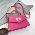 Hot pink trapezoid handbag with silver metal bow accent and detachable shoulder strap - Rose Red
