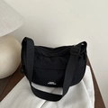 Minimalist black crescent nylon crossbody bag with adjustable strap and fashion label - Black