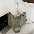 Morandi green large capacity nylon crossbody bag with adjustable strap on bed - Green