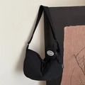 Solid black minimalist crescent crossbody bag with a detachable round coin purse - Black